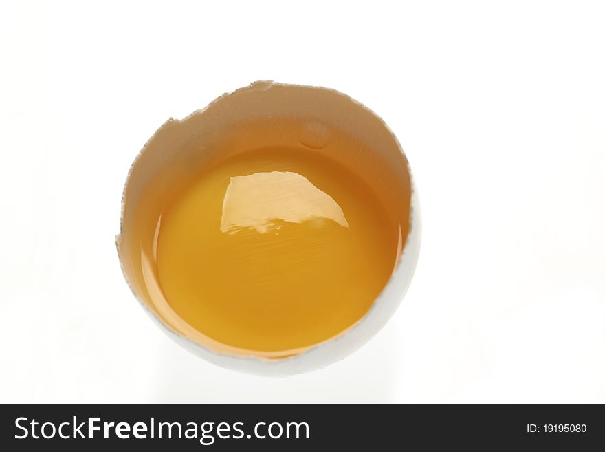 Egg yolk in an open eggshell