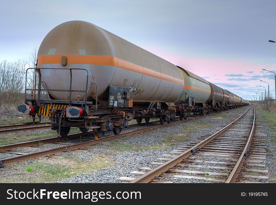 Tanks with fuel being transported by rail, taken in backlit. Tanks with fuel being transported by rail, taken in backlit