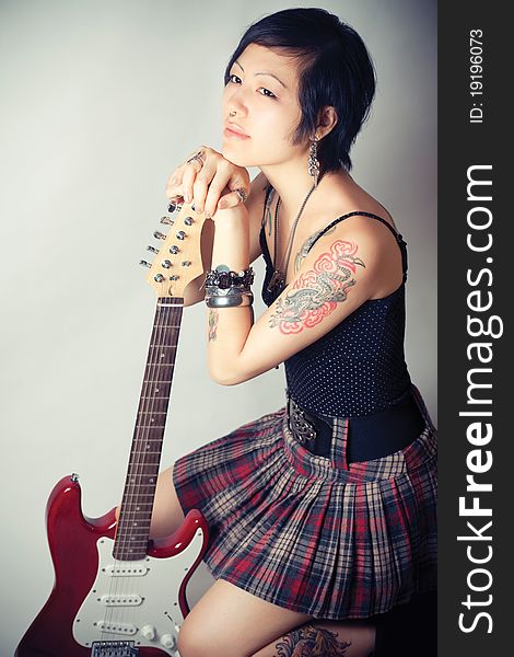 Funky young woman with her red hot guitar. Funky young woman with her red hot guitar.