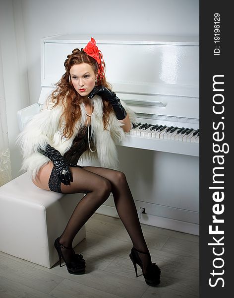 Beautiful young woman near piano. Beautiful young woman near piano