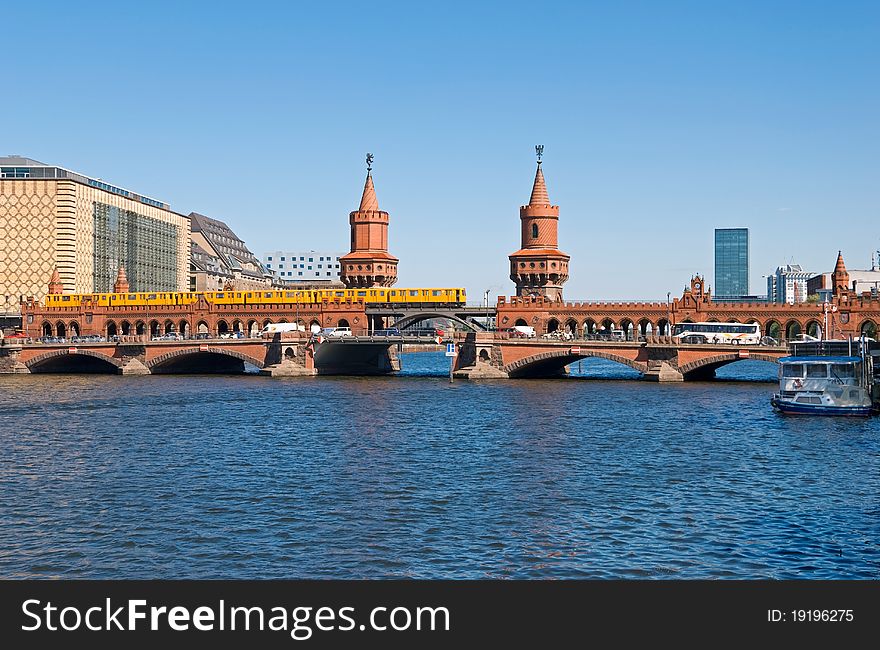 Berlin oberbaumbruecke bridge with passing orange subway train