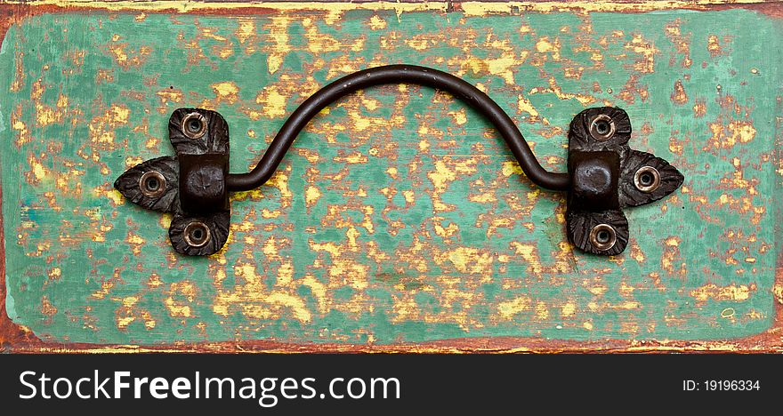 Black metal handle on green grunge background