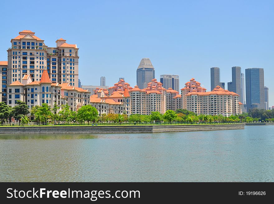 Apartments and buildings by the river at Kallang Basin, under the clear blue sky. Apartments and buildings by the river at Kallang Basin, under the clear blue sky