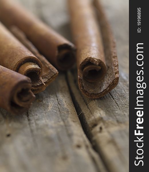 Cinnamon branches on the wooden background