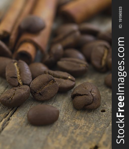 Coffee beans with cinnamon on the wooden background
