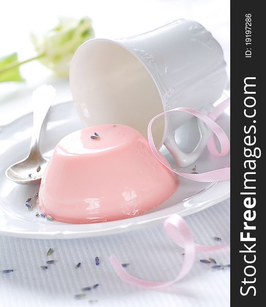 Panna Cotta (cream dessert) with cup on flower on background