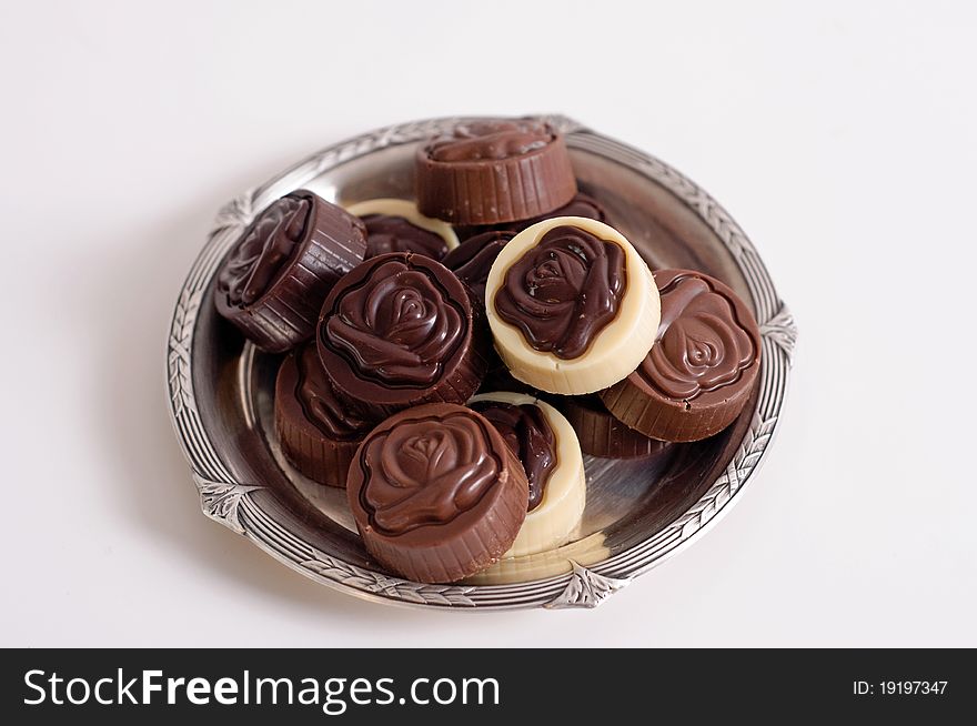 Photo of chocolate candies on white background