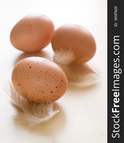 Three ecological brown eggs on wooden table