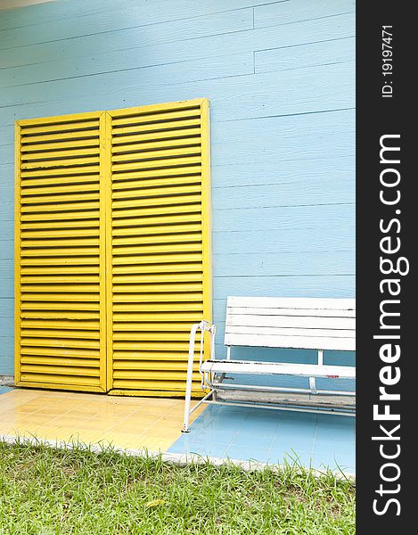 White bench and yellow door