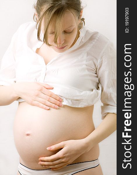 Pregnant woman with hands over tummy. Pregnant woman with hands over tummy