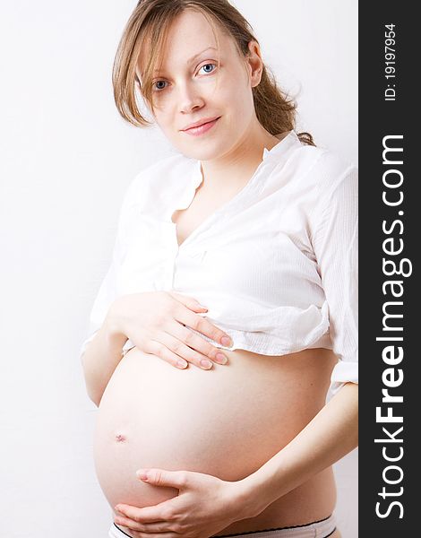 Pregnant woman with hands over tummy. Pregnant woman with hands over tummy