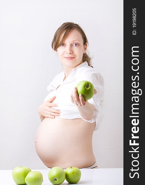 Pregnant woman holding green apple. Pregnant woman holding green apple