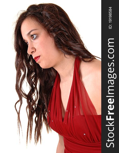 A closeup of a young pretty woman in a red dress in profile standing
in the studio for white background. A closeup of a young pretty woman in a red dress in profile standing
in the studio for white background.