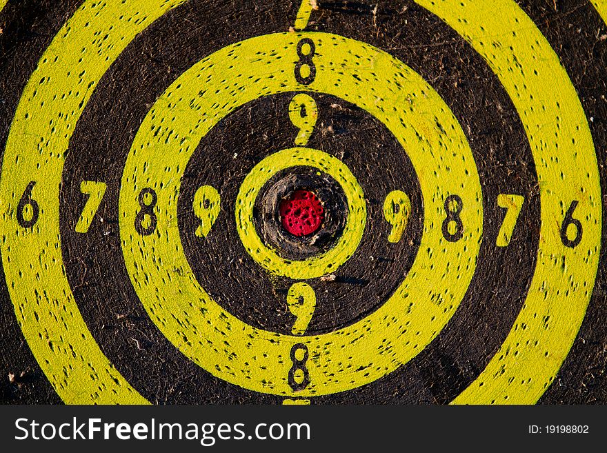 Old black and yellow wooden dartboard. Old black and yellow wooden dartboard