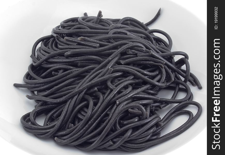 A portion of black spaghetti served on a white plate