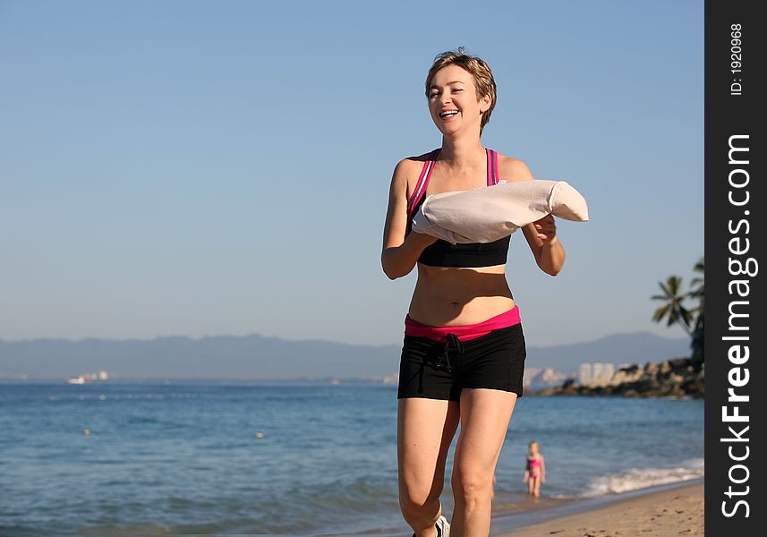 Young woman running alone on the beach. Young woman running alone on the beach