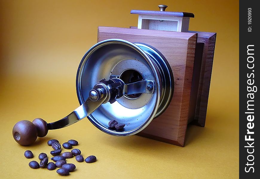 The overturned coffee grinder and the scattered grains of coffee