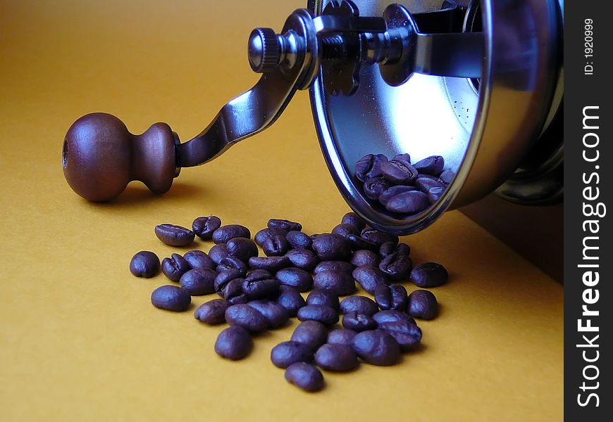 The overturned coffee grinder and the scattered grains of coffee