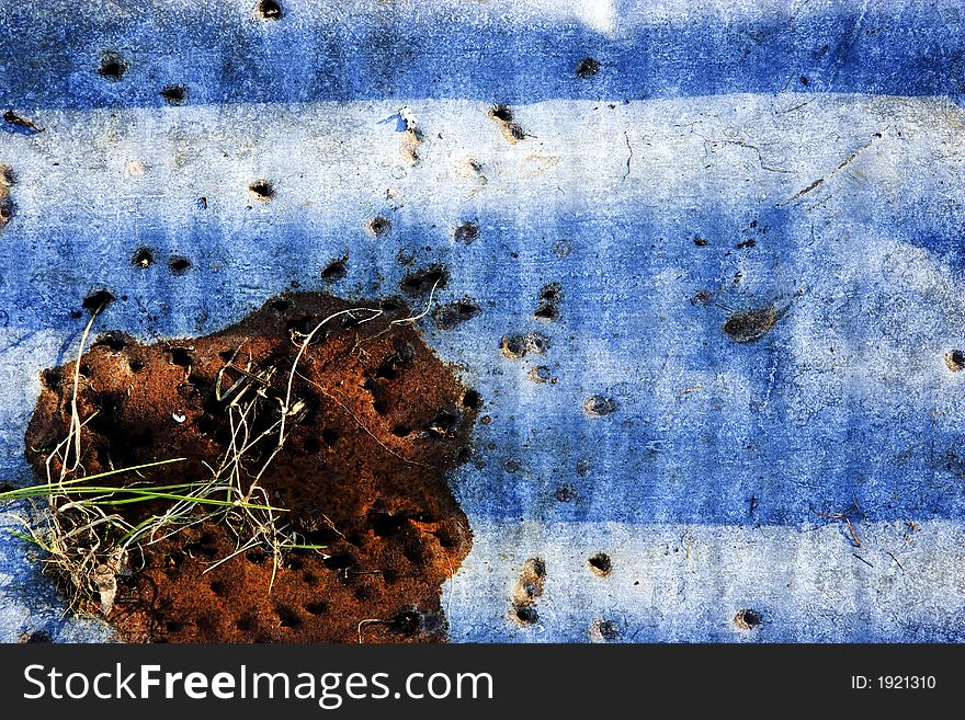 Rust and shotgun peppered corrugated sheet. Rust and shotgun peppered corrugated sheet