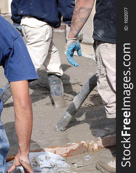 Men huslling around with boots in concrete. Men huslling around with boots in concrete