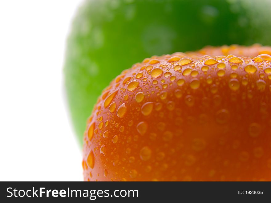 Fresh wet red tomato and green apple. Macro. Fresh wet red tomato and green apple. Macro.