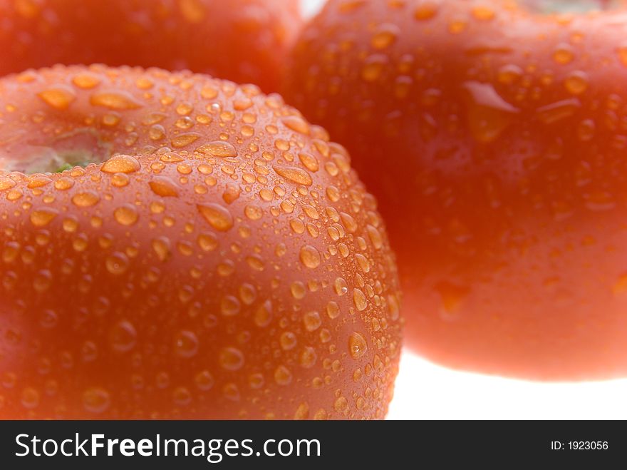 Fresh wet red tomato on white background. Fresh wet red tomato on white background.