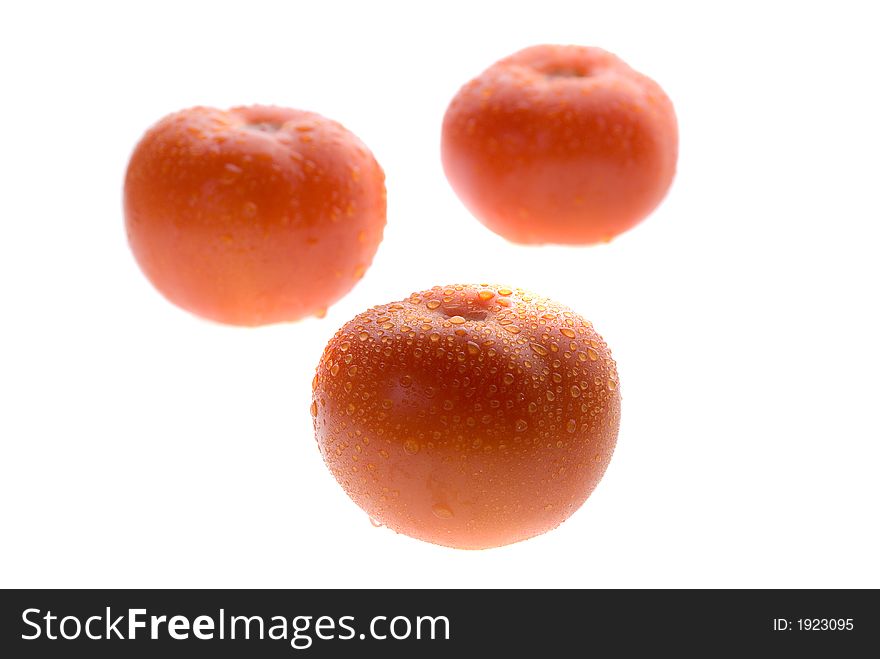 Fresh wet red tomato on white background. Fresh wet red tomato on white background.