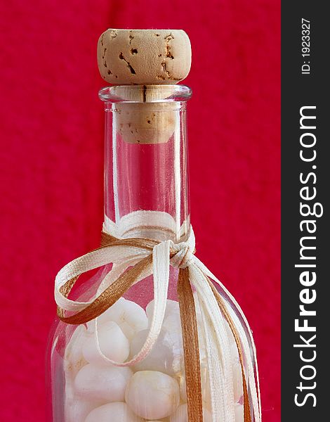 Bottle with small stones of marble from Thassos island, Greece