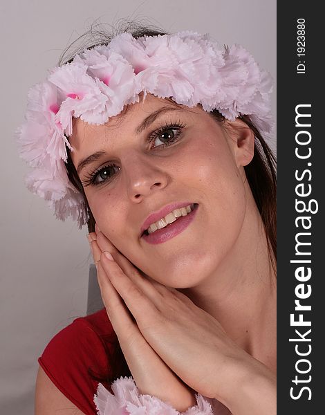 A beautiful hawaian looking girl smiles with flowers in her hair. A beautiful hawaian looking girl smiles with flowers in her hair.