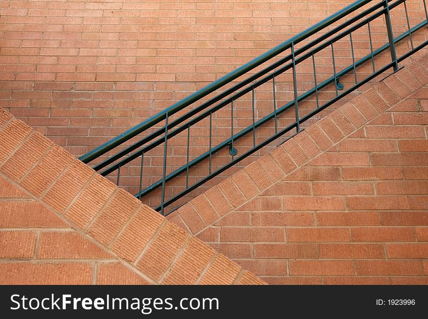 Brick staircase with iron railing.