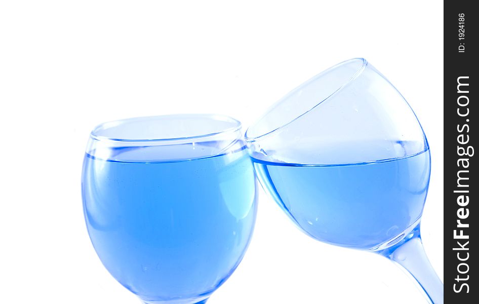 Glasses with a blue liquid on a white background