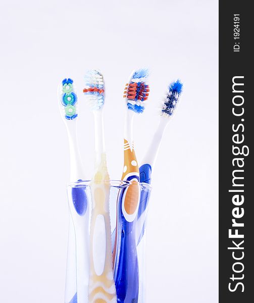 Diferent toothbrushes on a glass