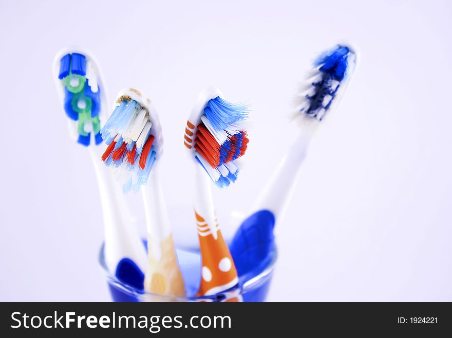 Diferent toothbrushes on a glass