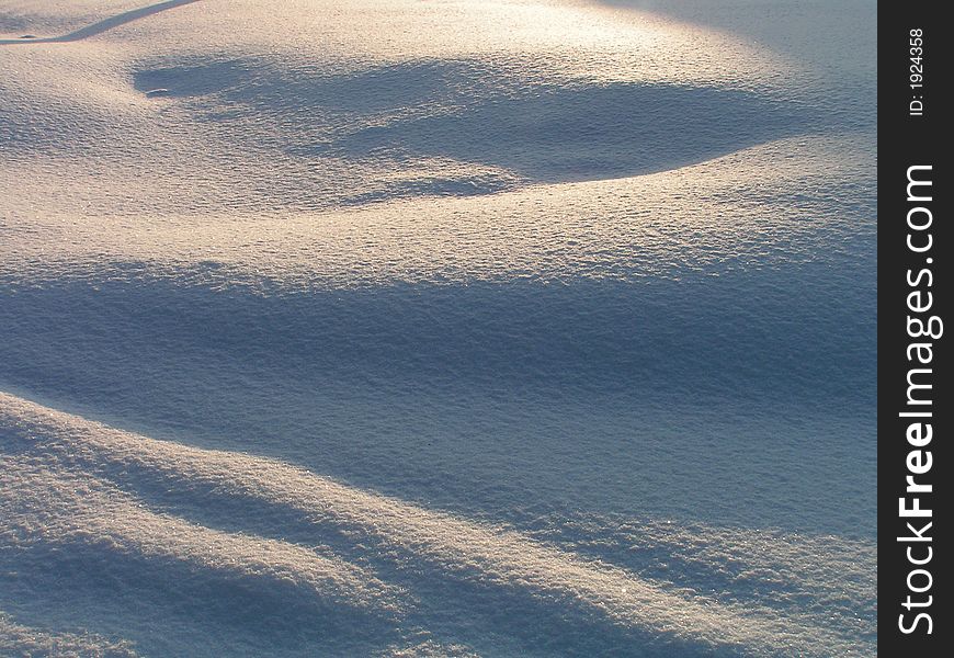 A snow cover covered by a sunlight. A snow cover covered by a sunlight.