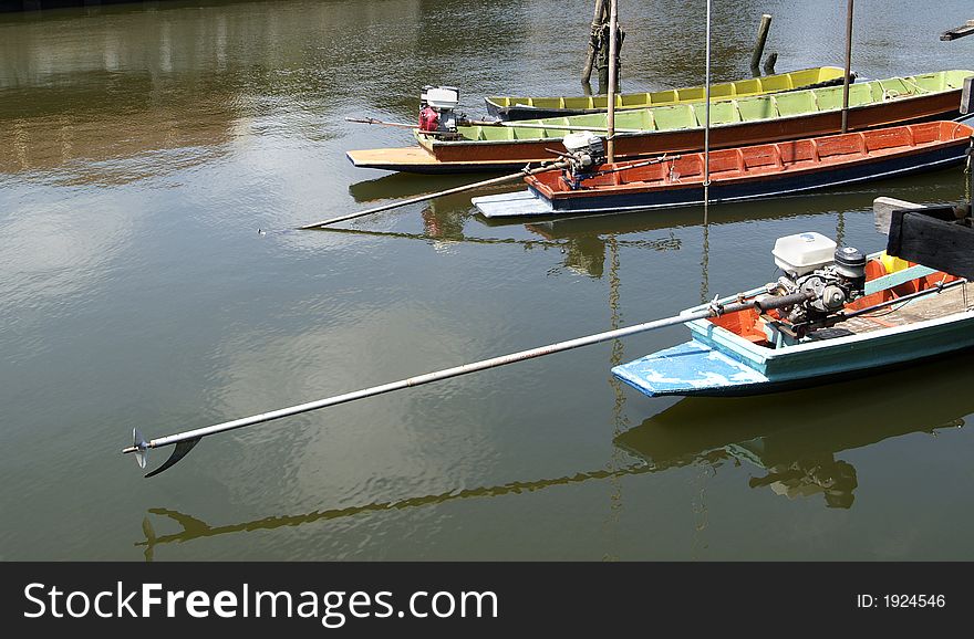 Colourful, small, wooden longtail boats on a canal in Thailand. Colourful, small, wooden longtail boats on a canal in Thailand