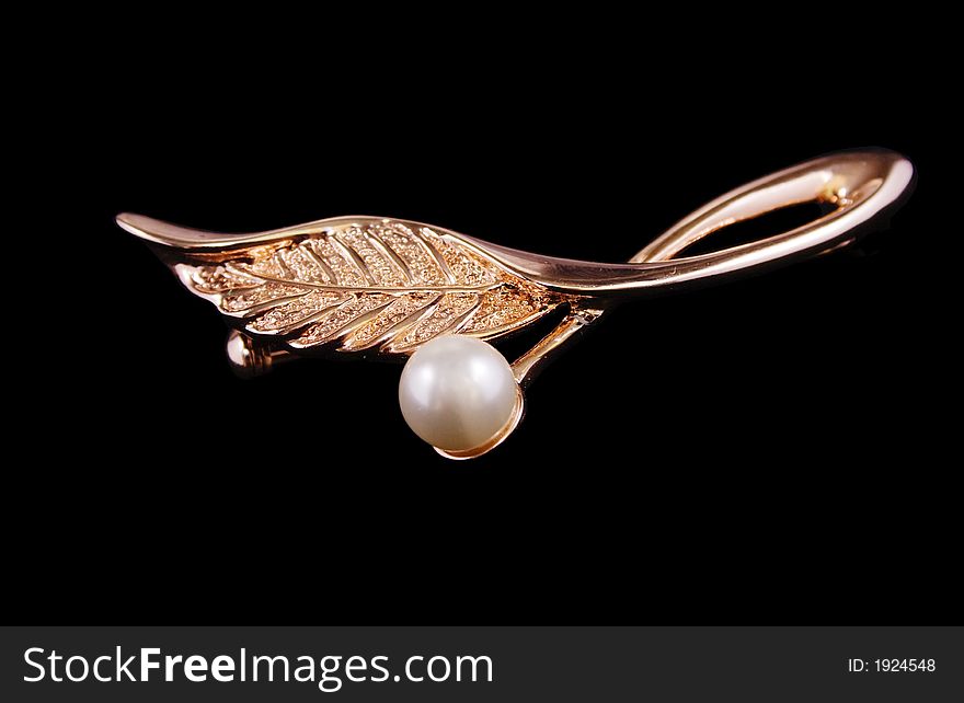 Golden ear-ring as a leaf with pearl. Golden ear-ring as a leaf with pearl
