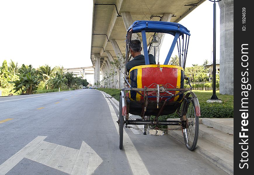 Trishaw under a bridge