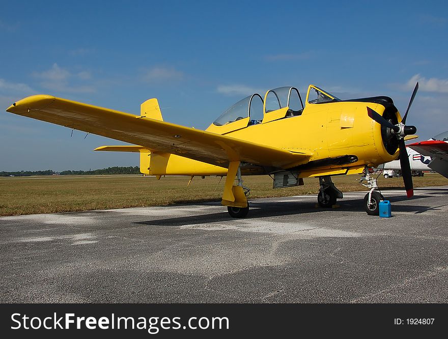 Vintage T-28 trainer airplane in yellow color