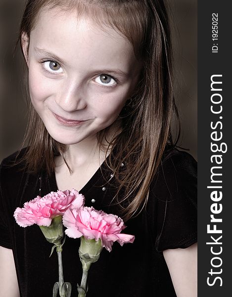 Closeup of girl with long hair holding flowers in her hands. Closeup of girl with long hair holding flowers in her hands