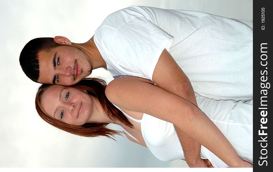 A happy young couple in an embrace outdoors. A happy young couple in an embrace outdoors