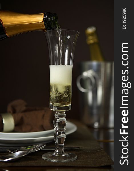 Pouring Champagne into a Champagne flute, or sparkling wine. Pouring Champagne into a Champagne flute, or sparkling wine