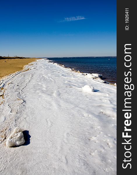 Frozen section of Atlantic beach with water and sand on either side. Frozen section of Atlantic beach with water and sand on either side.