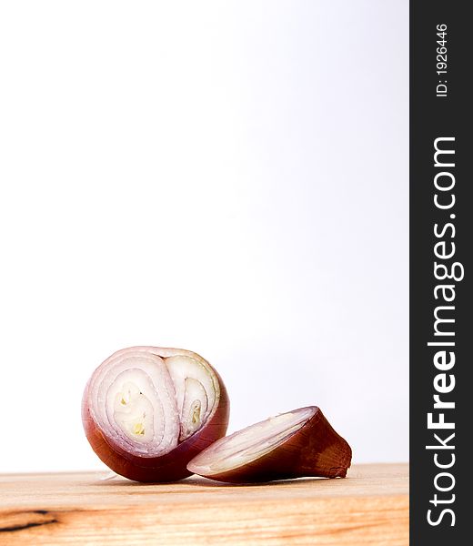 Sliced French shallot on a wooden board.