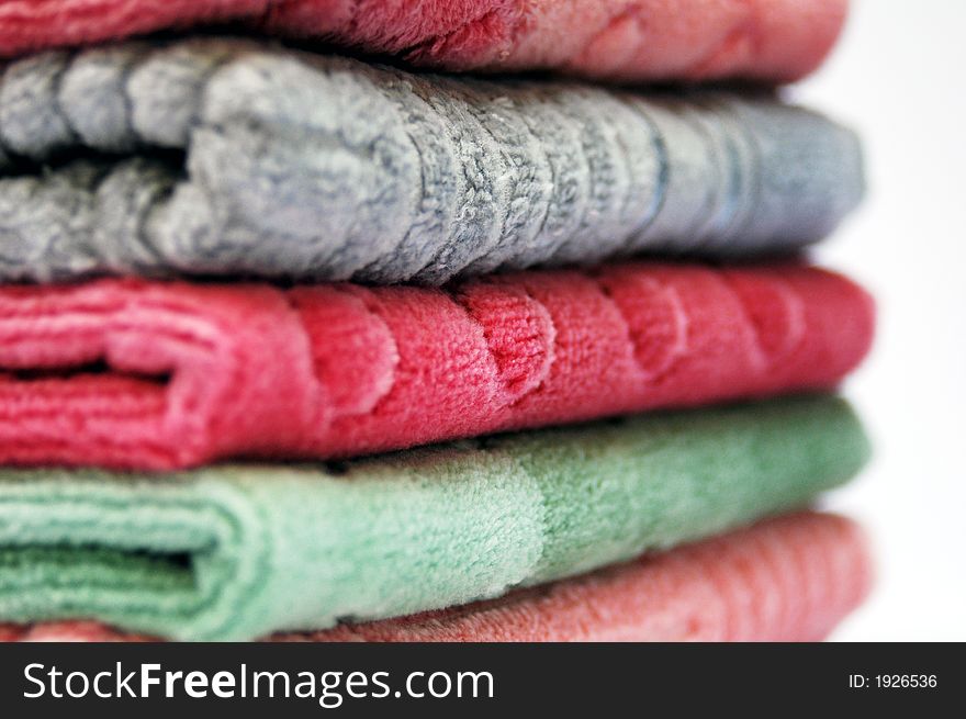 Bath towels of different colours piled on top of one another. Bath towels of different colours piled on top of one another