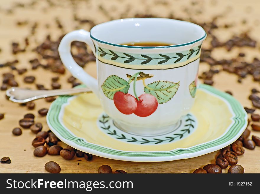 A pot of coffee on a wooden table. A pot of coffee on a wooden table