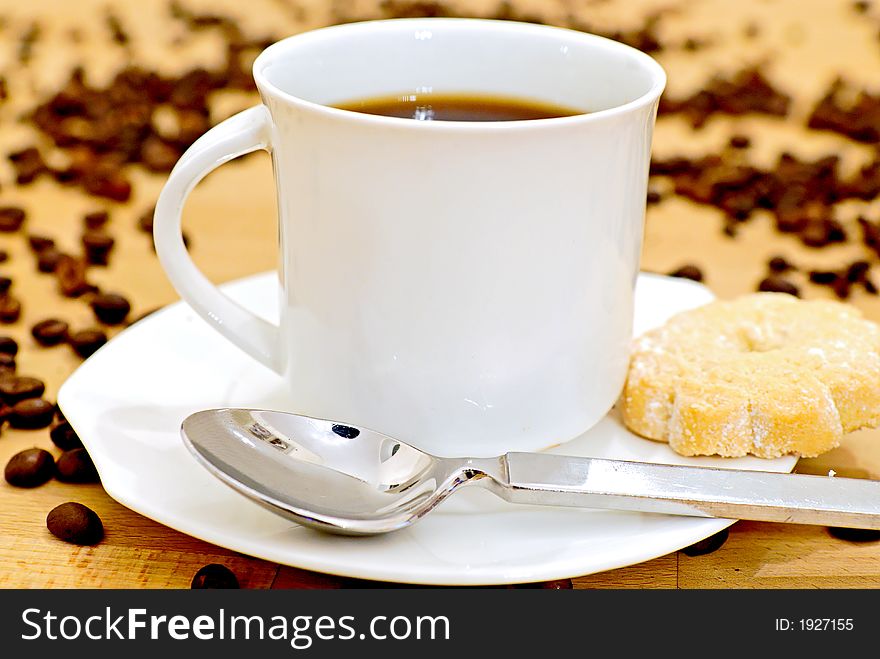 A pot of coffee on a wooden table. A pot of coffee on a wooden table