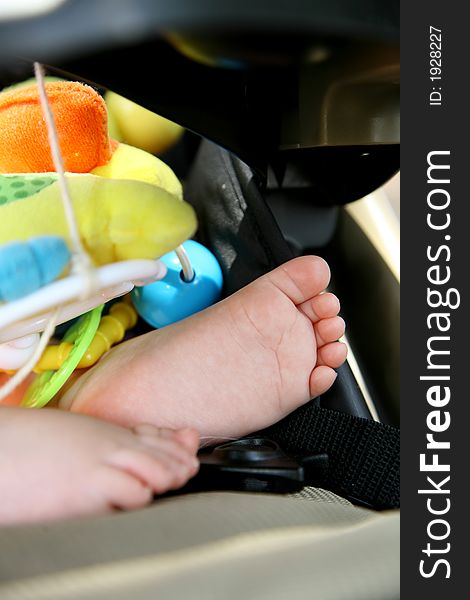 A little baby's feet inside a stroller. A little baby's feet inside a stroller