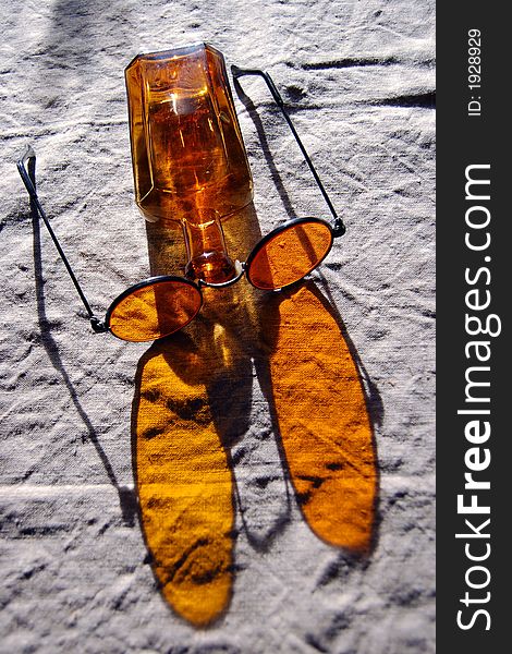 Orange bottle and glasses on the table