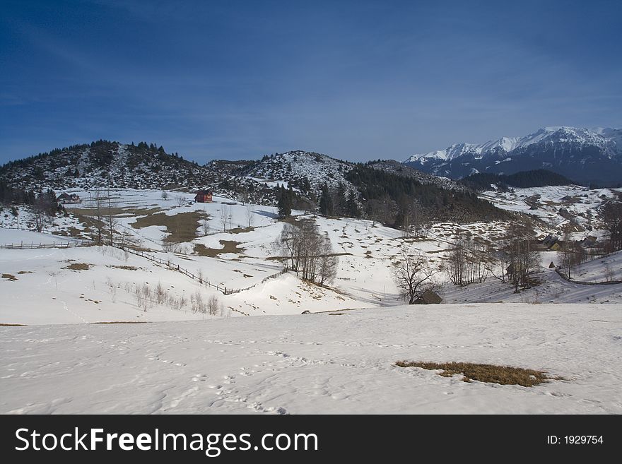 Winter landscape with red house