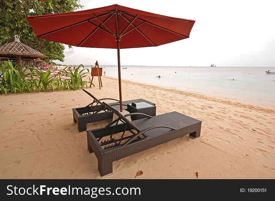 Two chairs and umbrella on Bali beach. Two chairs and umbrella on Bali beach